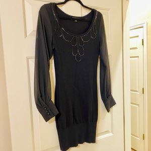 Black fitted stretchy sweater dress with lose sleeves and embroidery around neck